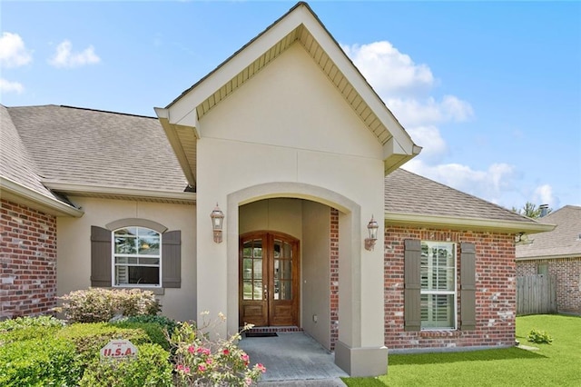 324 Nelson Landing Dr, Pearl River, LA 70452 - property entrance with french doors, a shingled roof, brick siding, and a lawn