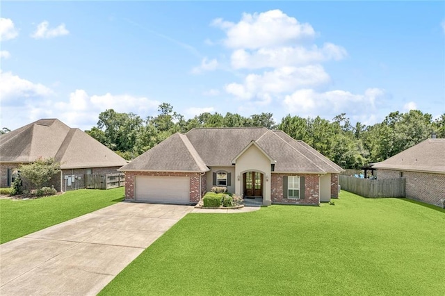 324 Nelson Landing Dr, Pearl River, LA 70452 - french country style house featuring a garage, driveway, brick siding, and french doors