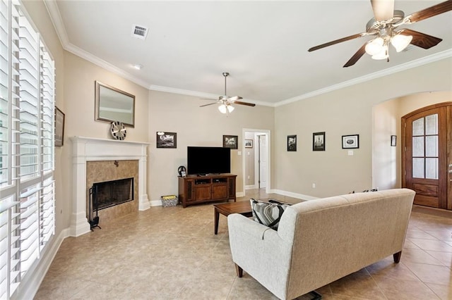 324 Nelson Landing Dr, Pearl River, LA 70452 - living room with ceiling fan, plenty of natural light, ornamental molding, a fireplace, and arched walkways