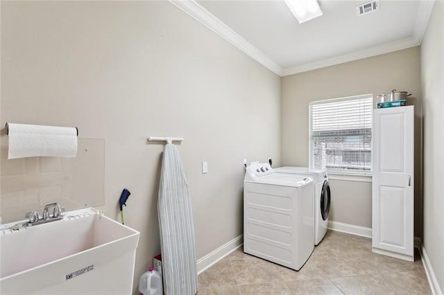 324 Nelson Landing Dr, Pearl River, LA 70452 - laundry area with washing machine and dryer, ornamental molding, and light tile patterned floors