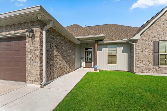 42333 Jasper Ln, Ponchatoula, LA 70454 - doorway to property with a lawn, a shingled roof, an attached garage, and brick siding
