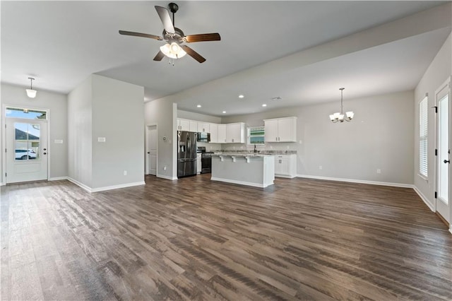 42333 Jasper Ln, Ponchatoula, LA 70454 - unfurnished living room with dark wood-type flooring, a chandelier, a ceiling fan, and recessed lighting