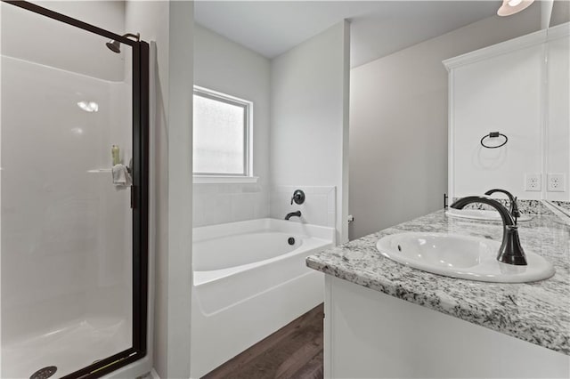 42333 Jasper Ln, Ponchatoula, LA 70454 - bathroom with wood finished floors, a garden tub, a stall shower, and double vanity