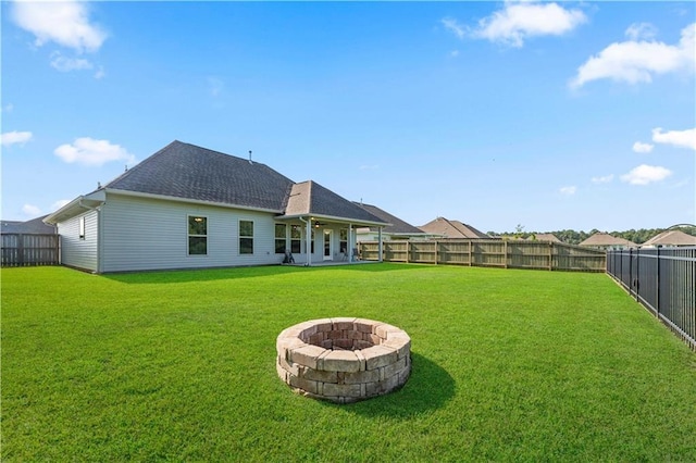 42333 Jasper Ln, Ponchatoula, LA 70454 - rear view of house with an outdoor fire pit, a fenced backyard, and roof with shingles