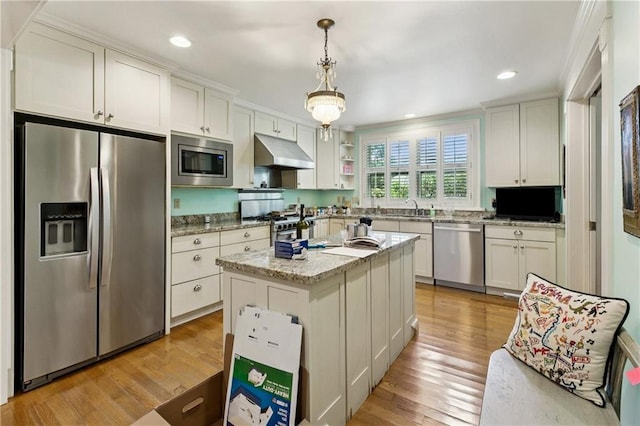 42 Crane St, New Orleans, LA 70124 - kitchen featuring stainless steel appliances, under cabinet range hood, light wood-style floors, decorative light fixtures, and light stone countertops