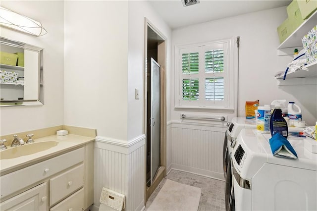 42 Crane St, New Orleans, LA 70124 - laundry area featuring washer and dryer and a wainscoted wall
