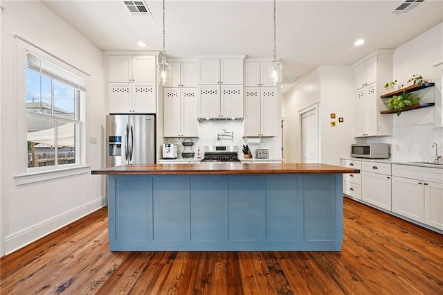110 Atlantic Ave, New Orleans, LA 70114 - kitchen with stainless steel appliances, open shelves, butcher block countertops, backsplash, and white cabinetry
