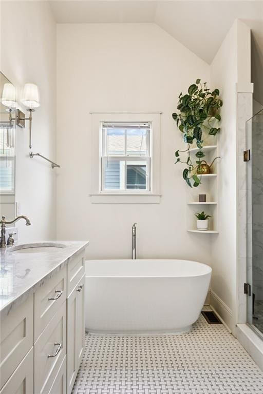 110 Atlantic Ave, New Orleans, LA 70114 - full bathroom featuring a soaking tub, a shower stall, double vanity, and lofted ceiling