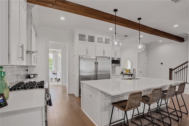6818 Louisville St, New Orleans, LA 70124 - kitchen with built in appliances, beam ceiling, backsplash, white cabinets, and recessed lighting