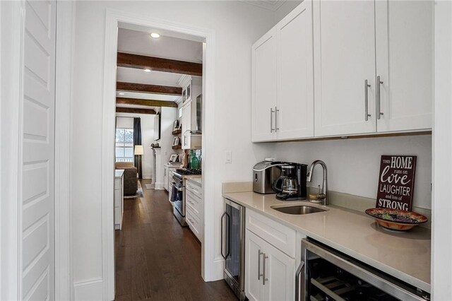 6818 Louisville St, New Orleans, LA 70124 - kitchen with wine cooler, high end stainless steel range oven, beam ceiling, white cabinetry, and recessed lighting