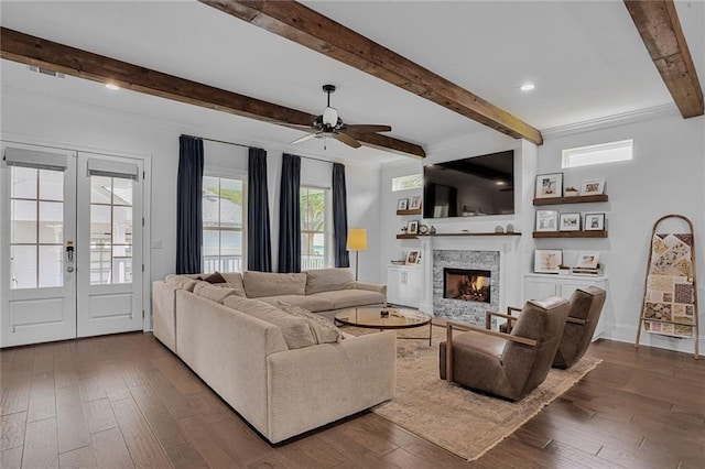 6818 Louisville St, New Orleans, LA 70124 - living area featuring beamed ceiling, a fireplace, ceiling fan, dark wood-style floors, and french doors
