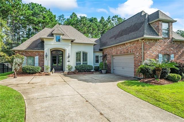 117 Grande Maison Blvd, Mandeville, LA 70471 - french country home featuring french doors, concrete driveway, a shingled roof, and brick siding