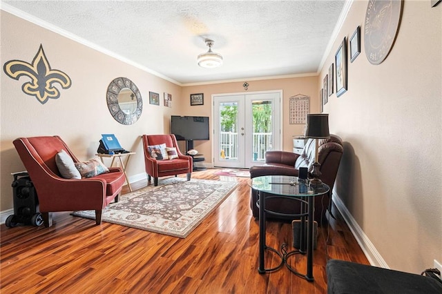 3805 Houma Blvd Unit C210, Metairie, LA 70006 - living room with wood finished floors, crown molding, french doors, and a textured ceiling