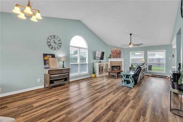497 Jj Ln, Covington, LA 70433 - living room featuring a ceiling fan, healthy amount of natural light, high vaulted ceiling, wood finished floors, and a chandelier