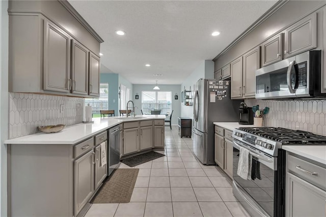 497 Jj Ln, Covington, LA 70433 - kitchen with stainless steel appliances, gray cabinets, a peninsula, decorative backsplash, and recessed lighting