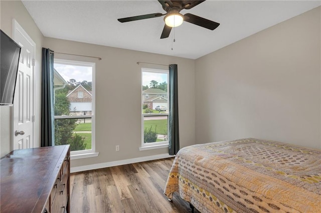 497 Jj Ln, Covington, LA 70433 - bedroom with wood finished floors and ceiling fan