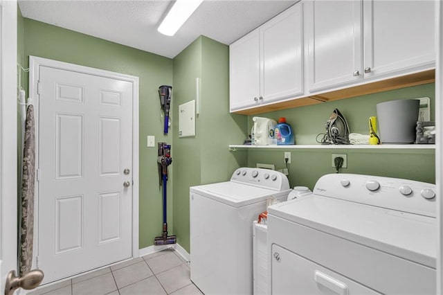 497 Jj Ln, Covington, LA 70433 - laundry area with cabinet space, light tile patterned flooring, and washing machine and clothes dryer