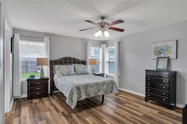 497 Jj Ln, Covington, LA 70433 - bedroom featuring wood finished floors, multiple windows, a textured ceiling, and ceiling fan