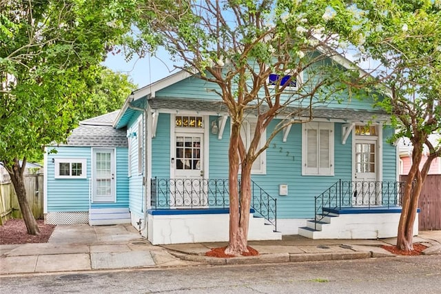 3221 N Rampart St, New Orleans, LA 70117 - shotgun-style home featuring roof with shingles