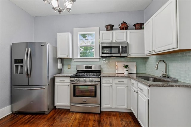 3221 N Rampart St, New Orleans, LA 70117 - kitchen with stainless steel appliances, a chandelier, and white cabinets