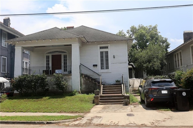 5326 Prytania St, New Orleans, LA 70115 - view of front of property with stairway, covered porch, roof with shingles, and a front yard
