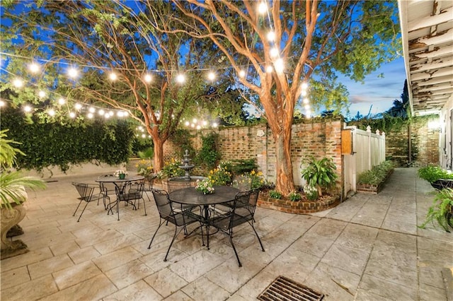521 Dauphine St, New Orleans, LA 70112 - fenced backyard with outdoor dining area and a patio