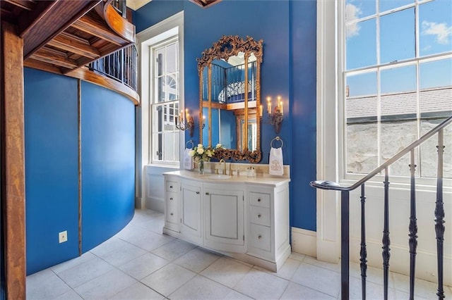 521 Dauphine St, New Orleans, LA 70112 - bathroom with tile patterned flooring, vanity, and plenty of natural light