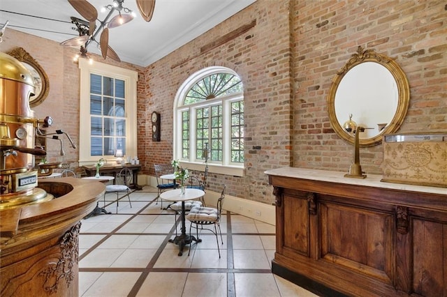521 Dauphine St, New Orleans, LA 70112 - interior space featuring inlaid floor details, brick wall, vanity, and ceiling fan