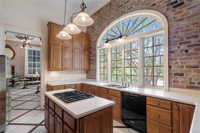 521 Dauphine St, New Orleans, LA 70112 - kitchen featuring stainless steel appliances, inlaid floor details, light countertops, decorative light fixtures, and brick wall