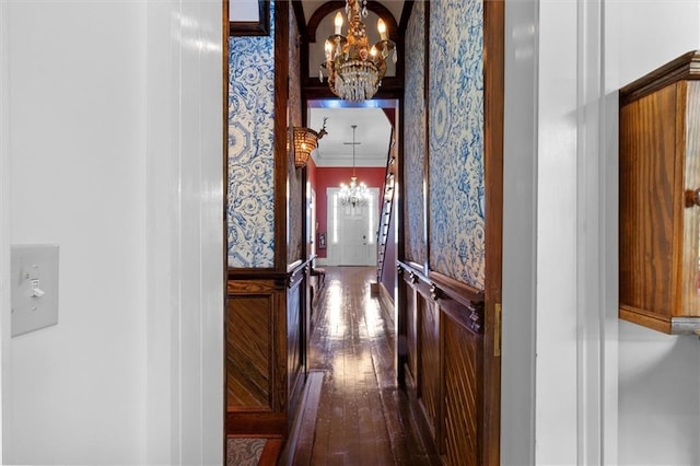 521 Dauphine St, New Orleans, LA 70112 - hall featuring a chandelier, dark wood-style flooring, and ornamental molding