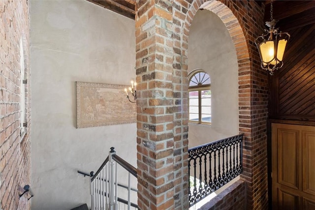 521 Dauphine St, New Orleans, LA 70112 - stairway featuring a chandelier and arched walkways
