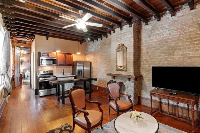 521 Dauphine St, New Orleans, LA 70112 - living room with beam ceiling, a ceiling fan, and hardwood / wood-style floors