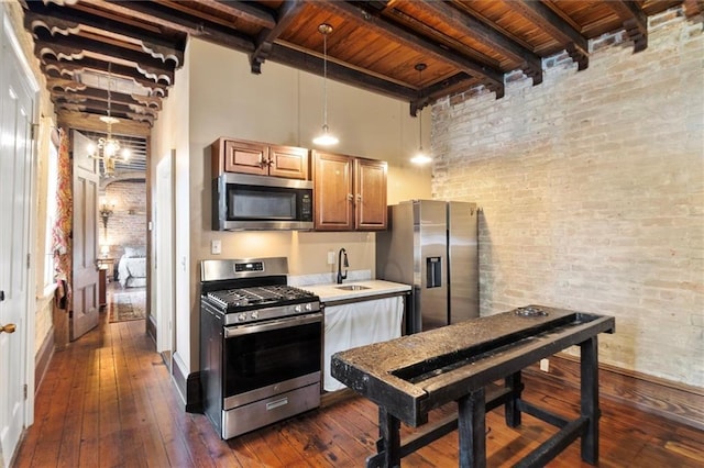521 Dauphine St, New Orleans, LA 70112 - kitchen featuring stainless steel appliances, brick wall, a wooden ceiling with exposed beams, light countertops, and dark wood-style flooring
