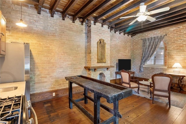 521 Dauphine St, New Orleans, LA 70112 - dining area featuring wood-type flooring, brick wall, ceiling fan, and a wooden ceiling with exposed beams