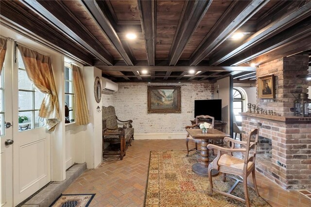 521 Dauphine St, New Orleans, LA 70112 - living room with a wall mounted AC, brick flooring, a wooden ceiling with exposed beams, and a brick fireplace