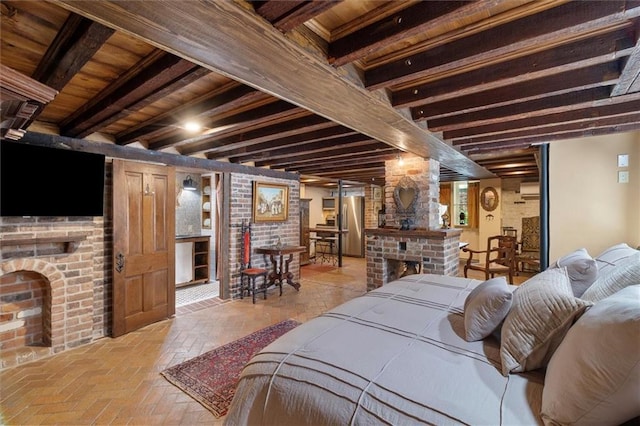 521 Dauphine St, New Orleans, LA 70112 - bedroom with a fireplace, freestanding refrigerator, and brick flooring