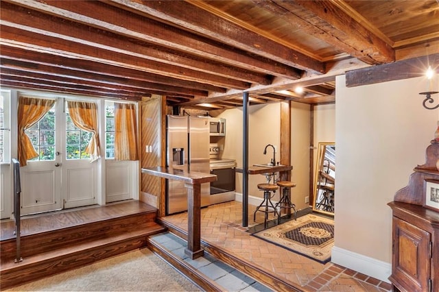 521 Dauphine St, New Orleans, LA 70112 - basement featuring stainless steel fridge, wooden ceiling, and brick patterned flooring