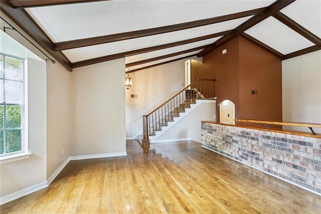104 Magnolia Dr, Belle Chasse, LA 70037 - unfurnished living room featuring stairway, wood finished floors, and arched walkways