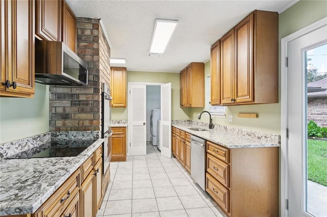 104 Magnolia Dr, Belle Chasse, LA 70037 - kitchen featuring appliances with stainless steel finishes, light stone counters, brown cabinets, light tile patterned flooring, and a textured ceiling