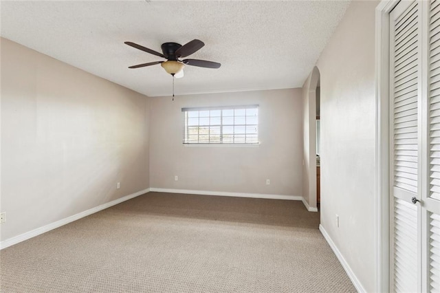 104 Magnolia Dr, Belle Chasse, LA 70037 - unfurnished bedroom featuring carpet, a closet, a textured ceiling, a ceiling fan, and arched walkways