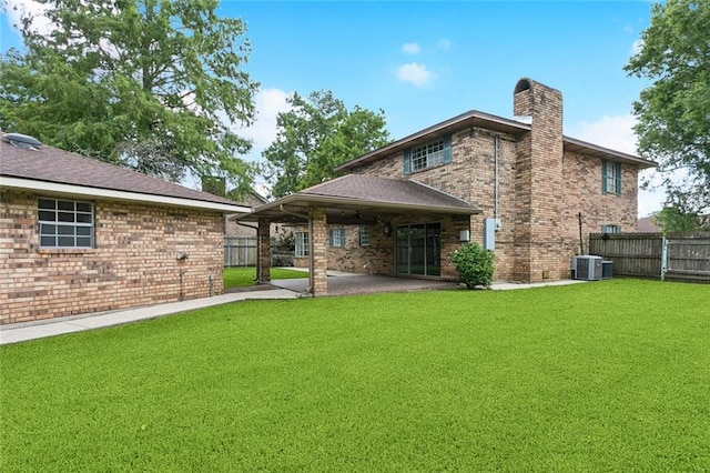 104 Magnolia Dr, Belle Chasse, LA 70037 - back of property with a chimney, a patio, and brick siding
