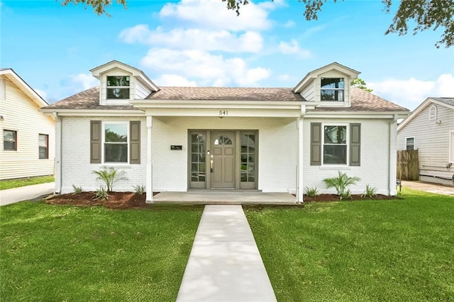 541 Jefferson Park Ave, Jefferson, LA 70121 - view of front of home with brick siding, a front lawn, and a shingled roof