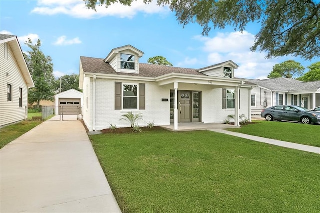 541 Jefferson Park Ave, Jefferson, LA 70121 - view of front facade featuring brick siding, an outdoor structure, a front lawn, driveway, and a garage