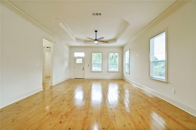 6032 Wingate Dr, New Orleans, LA 70122 - empty room featuring light wood-style flooring, a ceiling fan, a tray ceiling, and crown molding