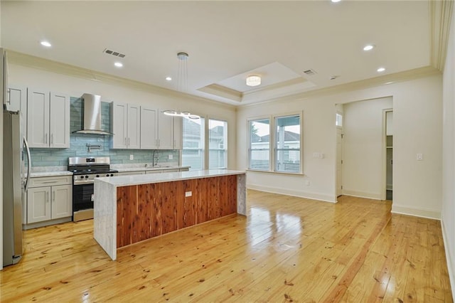 6032 Wingate Dr, New Orleans, LA 70122 - kitchen featuring stainless steel appliances, wall chimney exhaust hood, ornamental molding, light countertops, and tasteful backsplash