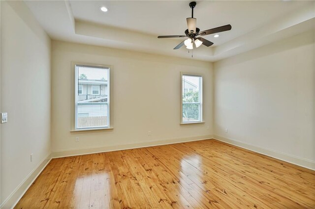6032 Wingate Dr, New Orleans, LA 70122 - empty room featuring light wood finished floors, a raised ceiling, ceiling fan, and recessed lighting