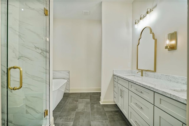 6032 Wingate Dr, New Orleans, LA 70122 - full bathroom featuring a soaking tub, double vanity, and a marble finish shower