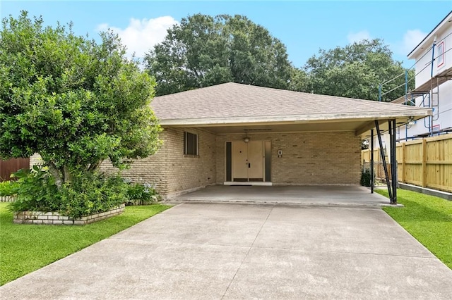 953 Homestead Ave, Metairie, LA 70005 - ranch-style home with concrete driveway, brick siding, an attached carport, and a shingled roof