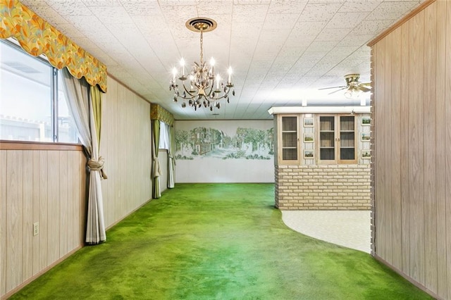 953 Homestead Ave, Metairie, LA 70005 - unfurnished dining area featuring carpet, wood walls, a chandelier, and a ceiling fan