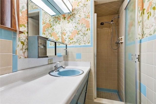 953 Homestead Ave, Metairie, LA 70005 - full bathroom featuring wallpapered walls, a shower stall, vanity, and tile walls